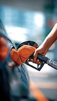 A person filling up their car with gas photo