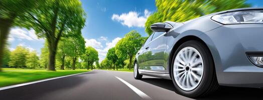 A car driving down the road with trees in the background photo
