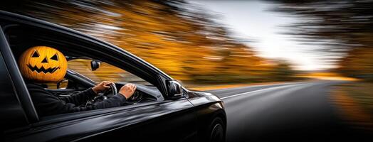 A person driving a car with a pumpkin face on the dashboard photo