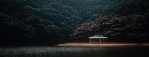 A gazebo sits on the edge of a lake surrounded by trees photo