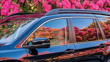 A black suv with flowers in the background photo