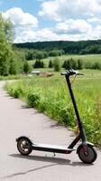 A black scooter on a paved road photo