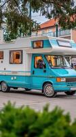 A blue and white camper van photo
