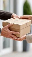 A man handing a package to another person photo