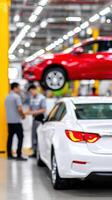 A car is being inspected in a factory photo
