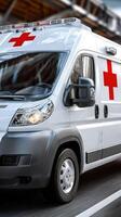 A white ambulance is driving down the road photo