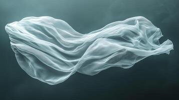 White transparent smooth cloth floating on dark background photo