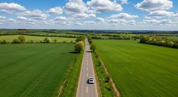 An aerial view of a car driving down a road photo