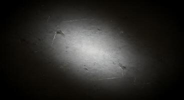 A dark and dirty wall with a light shining through it photo