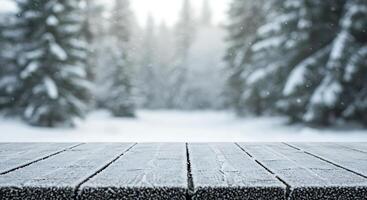 Winter landscape with wooden table and snow covered trees photo