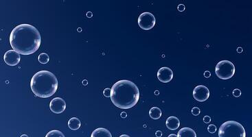 Soap bubbles floating in the air on a blue background photo