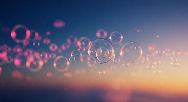 Bubbles floating in the air at sunset photo