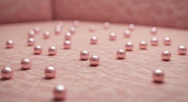 A bunch of small pearls on a pink surface photo