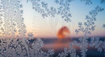 Frost on the window at sunset photo