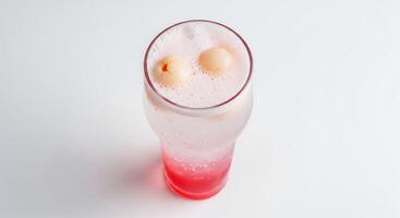 A glass of pink drink with two balls in it photo