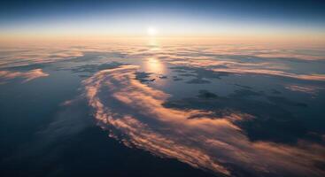 A view of the sun rising over clouds from an airplane photo