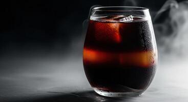 A glass of cola with smoke coming out of it photo