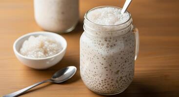 Two mason jars filled with rice and a spoon photo
