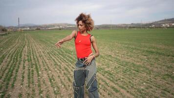 A Confident Young Woman Happily Posing in a Beautiful Green Field Surrounded by Nature video