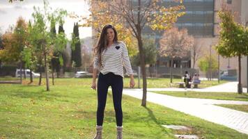 A Smiling Young Woman Enjoying a Beautiful Autumn Park While Wearing a Casual Outfit video