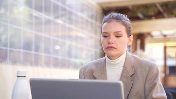 A Focused and Dedicated Professional Working Intently on a Laptop in a Modern Workspace Setting video