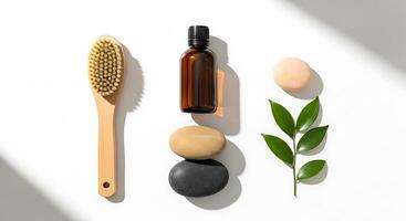 A bottle of essential oil, a brush, and a leaf photo