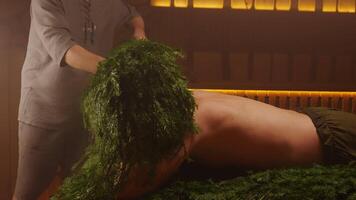 Professional Bath Attendant Putting Cool Spruce Branches On Head Of Client In Steam Bath video