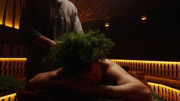 Adult Man Relaxing In Steam Bath When Bath Attendant Putting Juniper Branches On His Head video