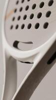 a close up of a tennis racket with holes on it photo