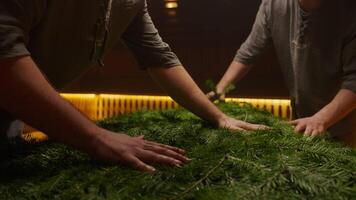 Two Professional Bath Attendants In Traditional Finnish Sauna, Putting Fir Branches For Aromatherapy video