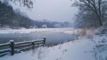 snowy winter landscape with frozen river and wooden fence photo