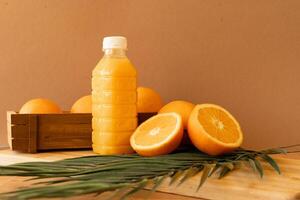 Bottle of orange juice with oranges photo
