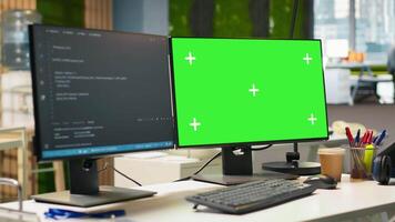 Green screen PC display on startup office desk showing programming languages written by developers. Mockup computer in company workspace used for code testing and quality assurance video