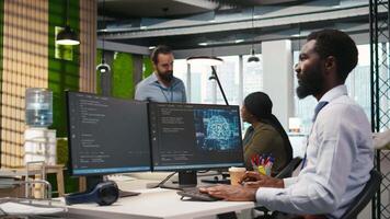 System administrator in office using PC, automating repetitive tasks with AI scripts. IT specialist using artificial intelligence technology to speed up feature implementation, camera A video