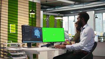 Engineer writing code on green screen PC, developing machine learning APIs. IT expert using mockup PC to troubleshoot software errors using artificial intelligence, camera A video