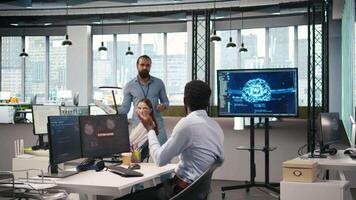 Programmer requests help from team leader to fix hacking attempt on corporate network. IT employee and manager investigating unauthorized access alerts, doing brainstorming, camera A video
