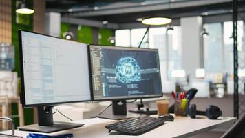 Advanced AI algorithms running on computer monitors in empty startup workspace deploying machine learning models. Artificial intelligence coding platform on PC screens in modern office video