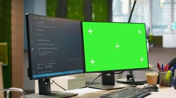 Green screen computer display in modern startup office displaying code snippets in various programming languages used for software development. Chroma key PC in empty software agency workplace video