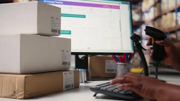 Close up of black employee scanning airway bill tags barcodes, registering the shipping labels numbers in the package tracking software. Using scanner to help with inventory in depot. Camera A. video