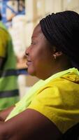Vertical African american worker with disability uses airway bill numbers for tracking info on software, monitoring the order parcel status in a distribution hub. Managing shipment operations. Camera A. video
