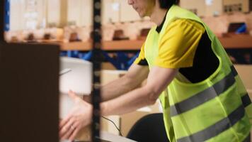 Warehouse worker scanning airway bills labels applied on cargo packages, monitoring shipping route on package tracking software. Registering the details for the logistics. Camera B. video