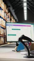 Vertical Asian male worker scanning shipment labels and tracking numbers in a distribution hub, ensures order management in fulfillment center. Using a scanner for transportation details. Camera A. video