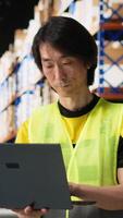 Vertical Distribution center staff managing package dispatch for a large brand, orders are processed quickly and efficiently ensuring express delivery of products packed with care. Warehouse depot. Camera B. video
