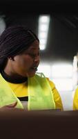 Vertical Diverse staff members organizing pallets on shelves and racks, processing orders in the industrial fulfillment center. Team handles distribution operations, managing inventory. Camera B. video