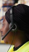 Vertical Call center clerk parcel tracking and order dispatch on help line, working in an online shopping logistics center. Worker resolving cargo issues and packages lost in distribution process. Camera A. video