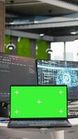 Vertical Isolated screen laptop in empty AI startup office displaying programming languages used for building applications. Chroma key notebook showing deep learning code in software development agency video