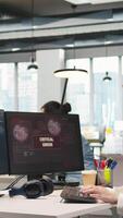 Vertical Young inexperienced developer in office struggling to fix critical error warning popup. Intern troubleshooting error notification on computer screen interrupting workflow, camera A video