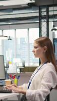 Vertical Female engineer using AI LLM chatbot, optimizing company systems performance. System administrator uses artificial intelligence assistant to convert manual workflows into automated scripts, camera A video