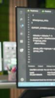 Vertical PC on office desk used to design and implement algorithms enabling deep learning. Artificial intelligence technology company workspace with computer used to conduct code reviews to fix bugs video