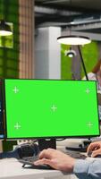 Vertical Technician in office using green screen PC, automating repetitive tasks with AI scripts. IT expert using artificial intelligence tech on mockup computer to speed up feature implementation, camera A video